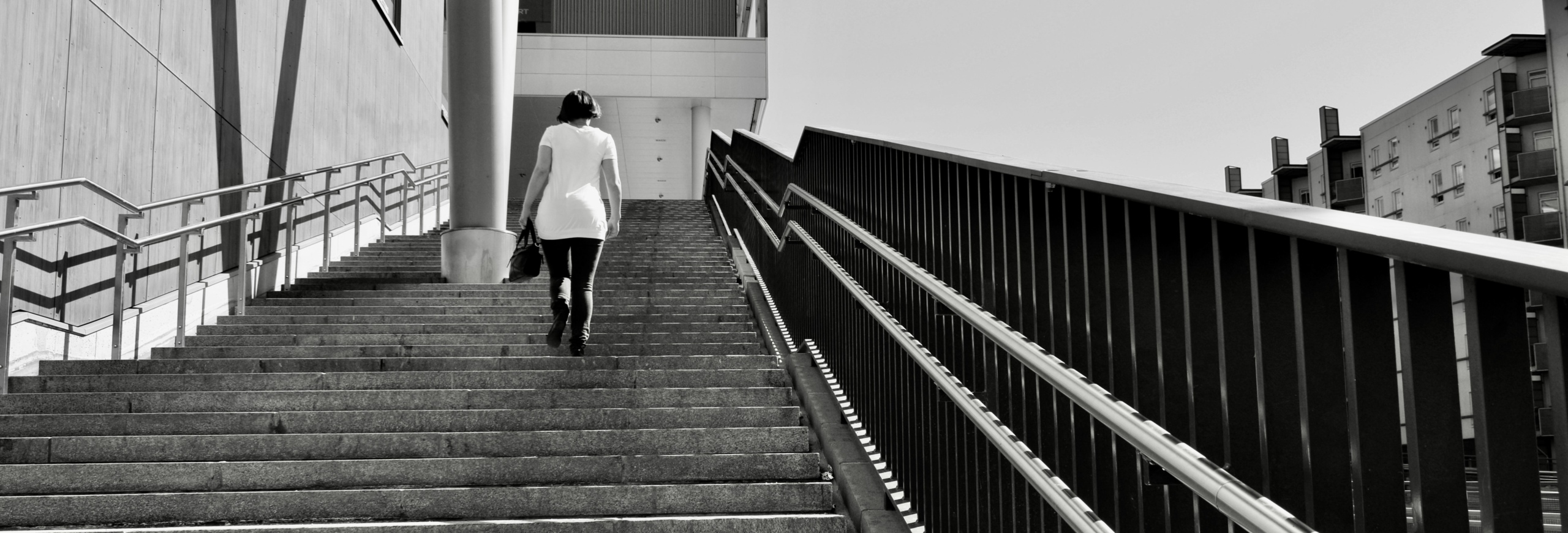 Woman walking up stairs, Metaphor for CRMs and donations in non profits