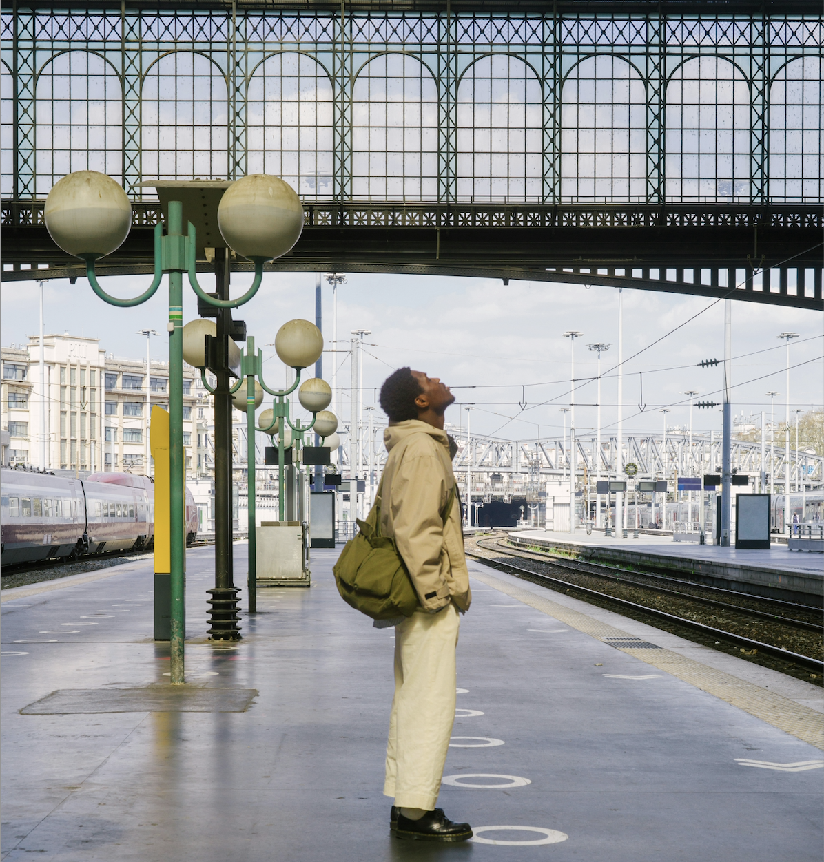 A person stands alone on an open train platform, head tilted back as a train departs in the background — a visual metaphor for the cost of inaction as AI adoption accelerates, and the moment of recognition that waiting is itself a choice with consequences for associations and the members they serve.